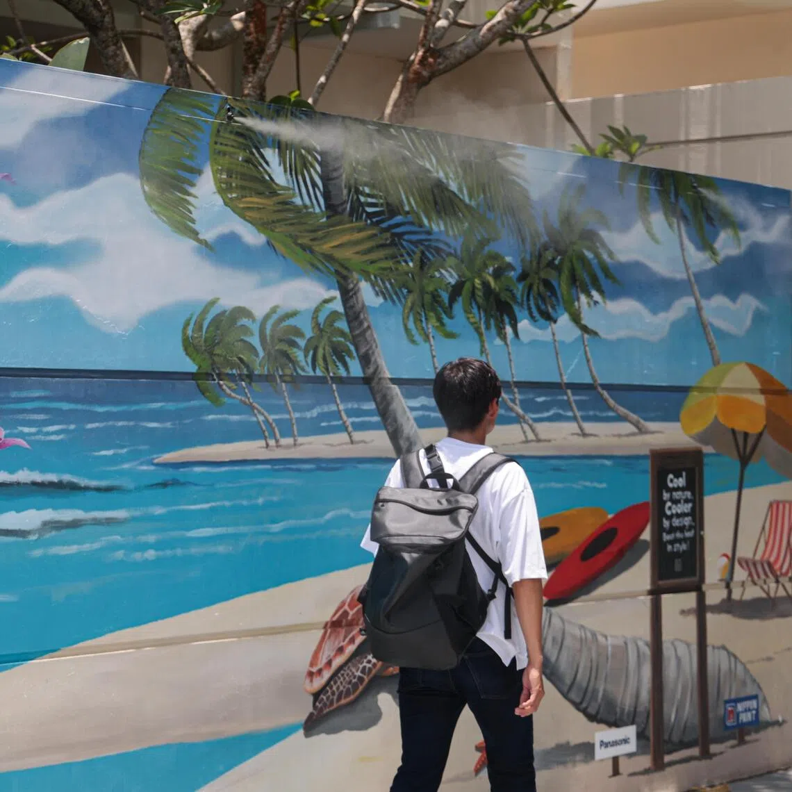 A cool node on Siloso Beach features a mural and ground coated with heat-reflective paint, and a misting system.