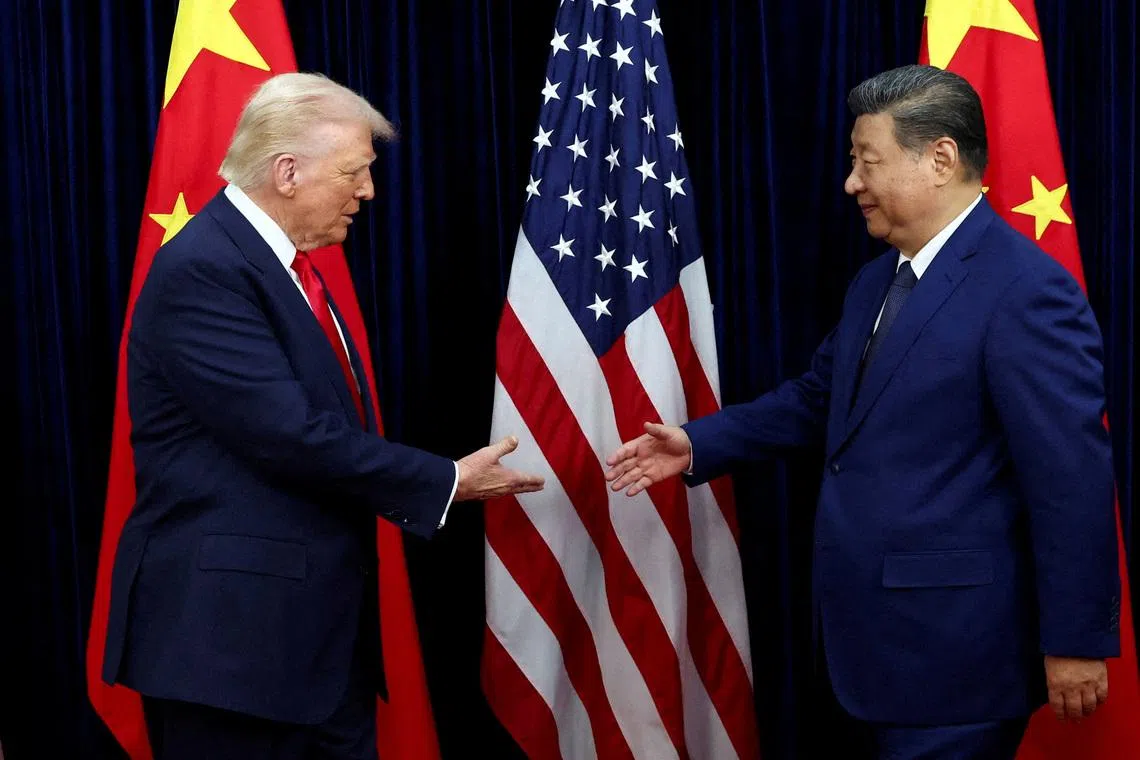 FILE PHOTO: U.S. President Donald Trump shakes hands with Chinese President Xi Jinping as they hold a bilateral meeting at Gimhae International Airport, on the sidelines of the Asia-Pacific Economic Cooperation (APEC) summit, in Busan, South Korea, October 30, 2025. REUTERS/Evelyn Hockstein//File Photo