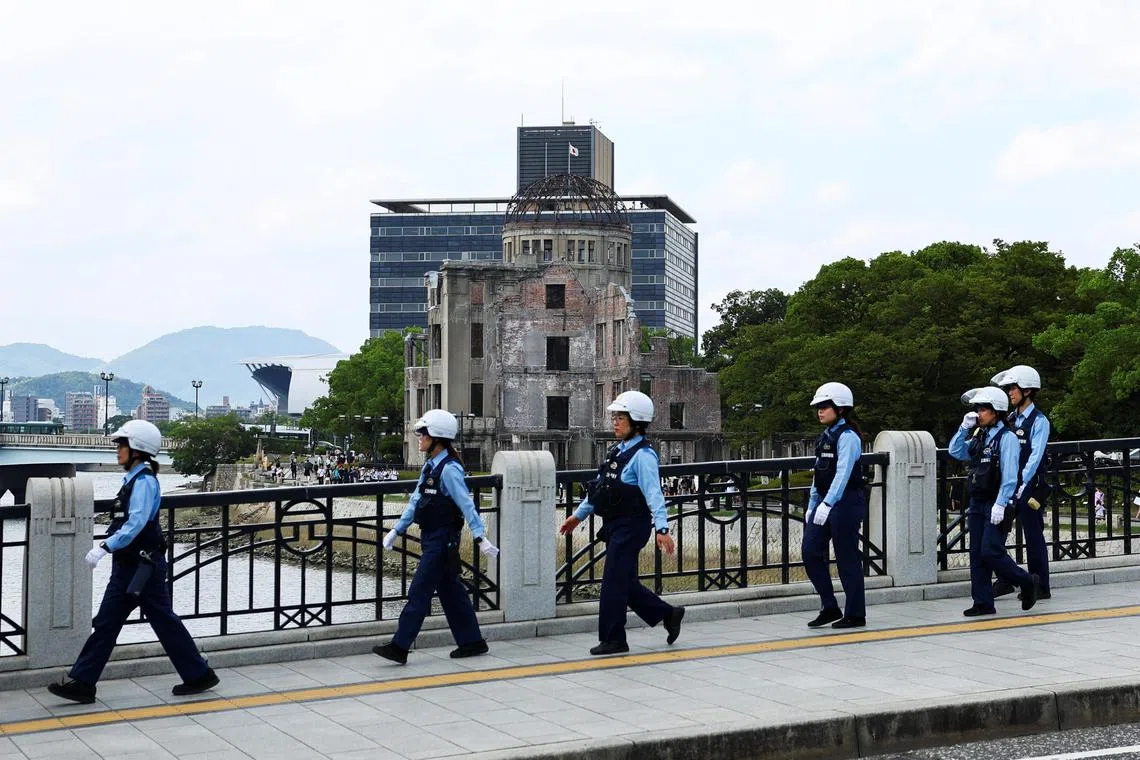 Female police officers walk around the dome ahead of the 80th anniversary World War Two atomic bombing , in Hiroshima, western Japan, August 5, 2025. REUTERS/Kim Kyung-Hoon
