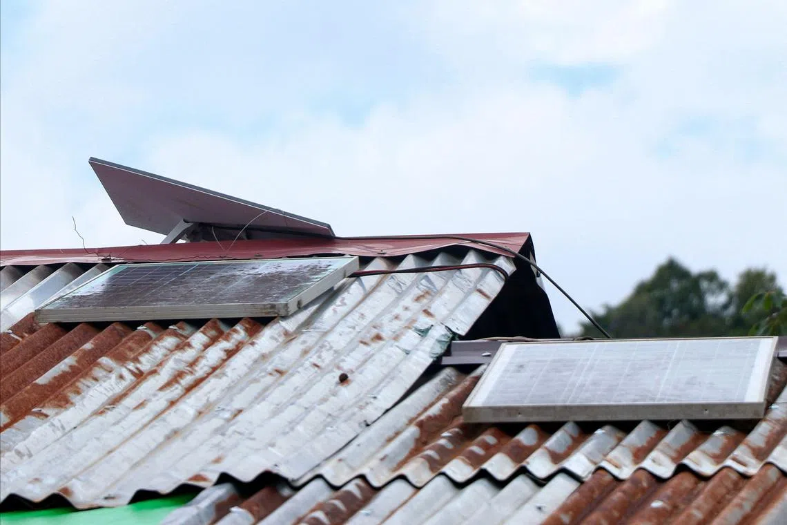 A Starlink antenna powered by solar panels on the roof of a shop in Myanmar.