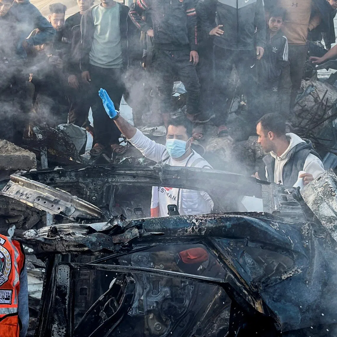 Emergency services work at the site of what medics said was an Israeli airstrike on a car near the entrance to Zawayda town, amid the U.S.-Israeli conflict with Iran, in the central Gaza Strip, April 4, 2026. Picture taken with a mobile phone.  REUTERS/Stringer