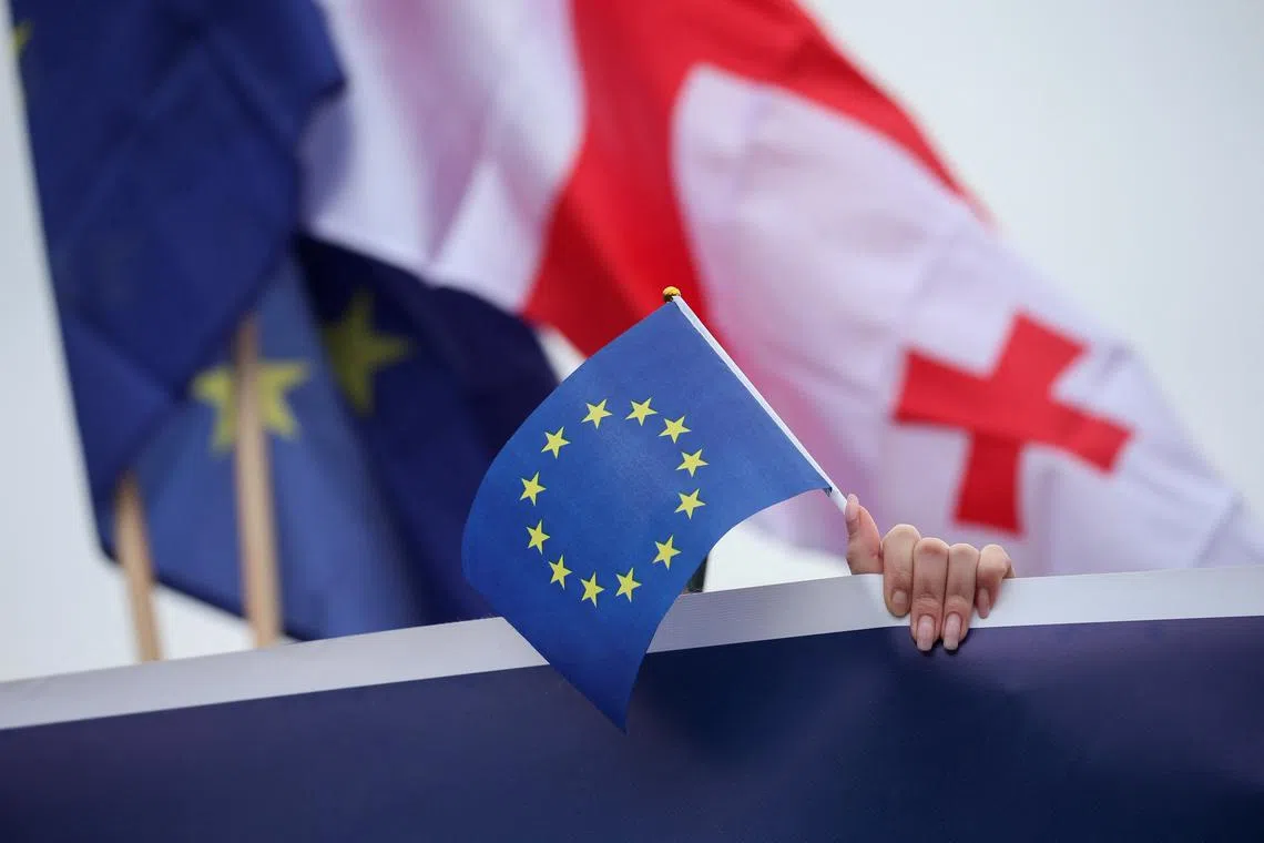 FILE PHOTO: A participant holds a EU flag during a procession in support of Georgia's membership in the European Union in Tbilisi, Georgia, December 9, 2023. REUTERS/Irakli Gedenidze/ File Photo
