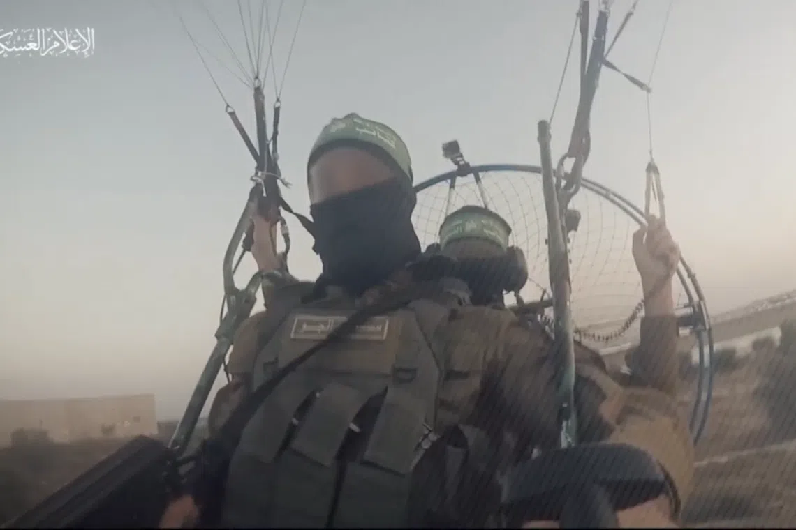 A screengrab from a video shared on the official channel of the Al-Qassam Brigades, which shows Hamas militants operating motorised paragliders. It is unconfirmed if this was taken during Hamas' incursion into Israel on Oct 7.