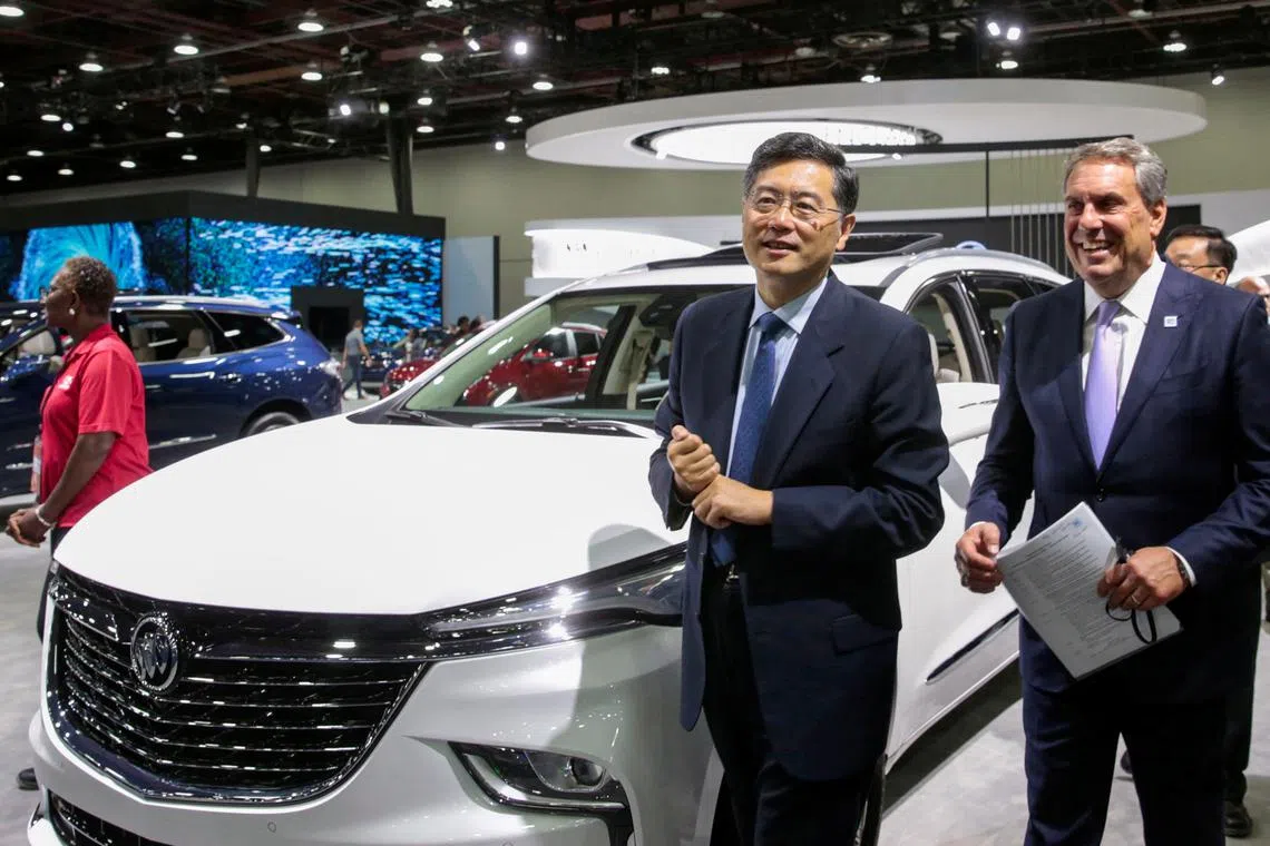 General Motors President Mark Reuss (R) and Chinese Ambassador to the U.S Qin Gang walk together during a media day of the North American International Auto Show in Detroit, Michigan, U.S. September 14, 2022.  REUTERS/Rebecca Cook

  