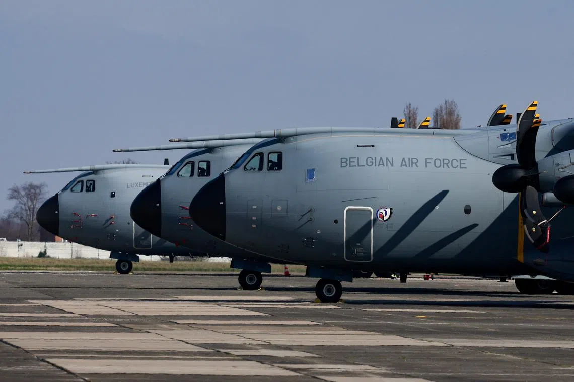 FILE PHOTO: A Belgian Air Force Airbus A400M Atlas is parked next to aircrafts, at Belgian military airport in Melsbroek, Belgium March 4, 2024. REUTERS/Yves Herman/File Photo