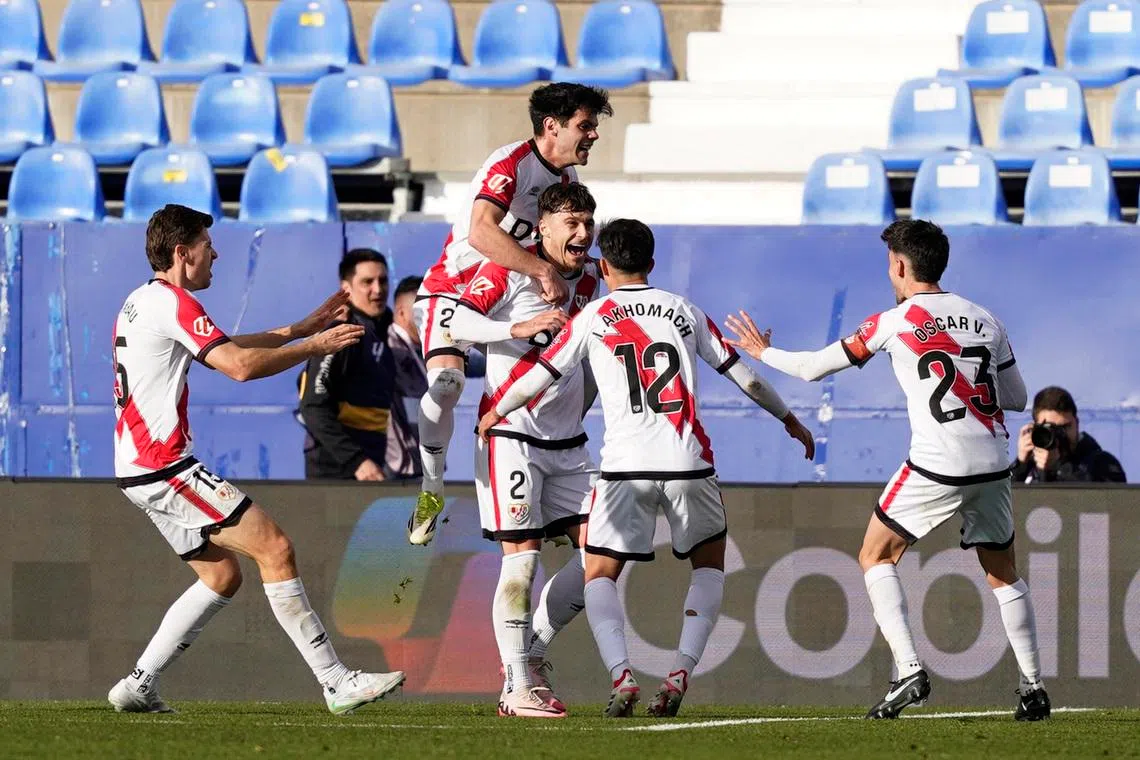 Soccer Football - LaLiga - Rayo Vallecano v Atletico Madrid - Estadio Municipal de Butarque, Leganes, Spain - February 15, 2026 Rayo Vallecano's Fran Perez celebrates scoring their first goal with teammates REUTERS/Ana Beltran