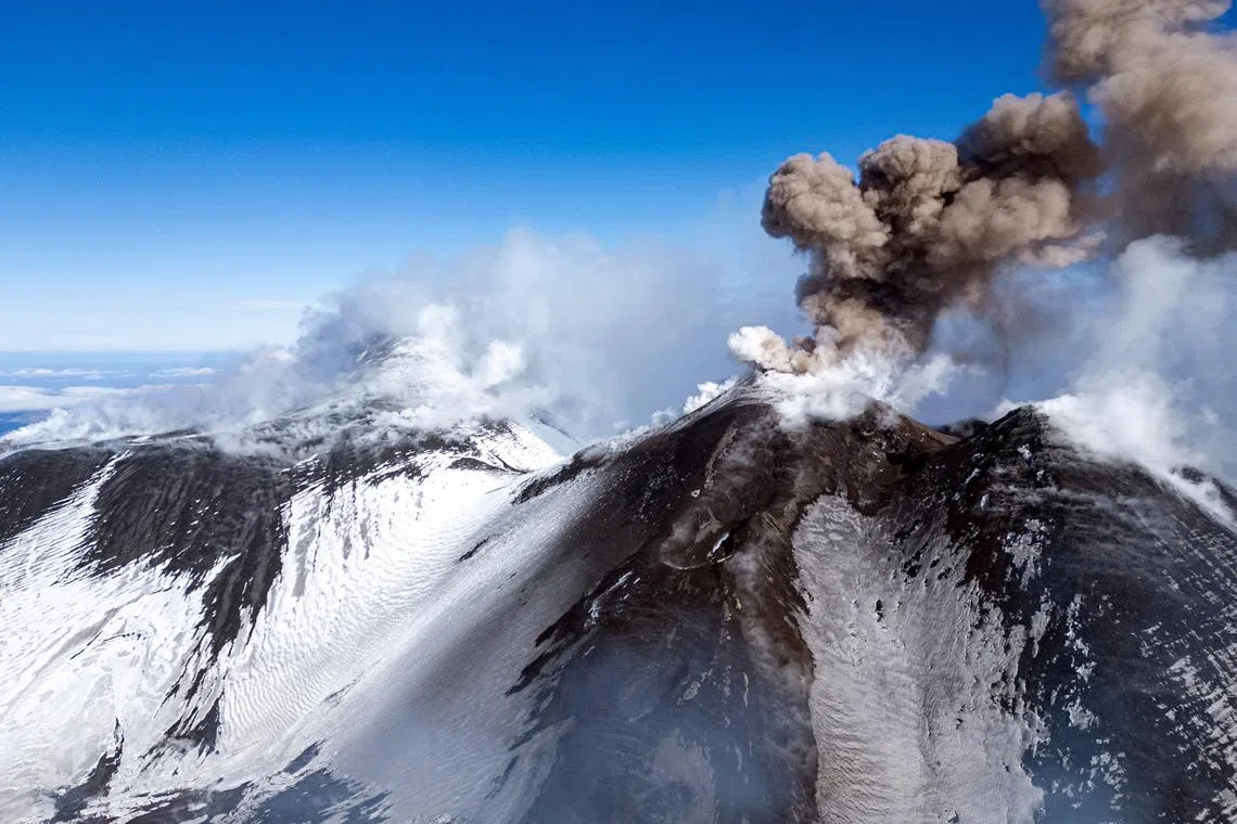 FILE PHOTO: Volcanic steam and ashes rise from Mount Etna, Italy, February 12, 2025. REUTERS/Etna Walk/Giuseppe Di Stefano/File Photo