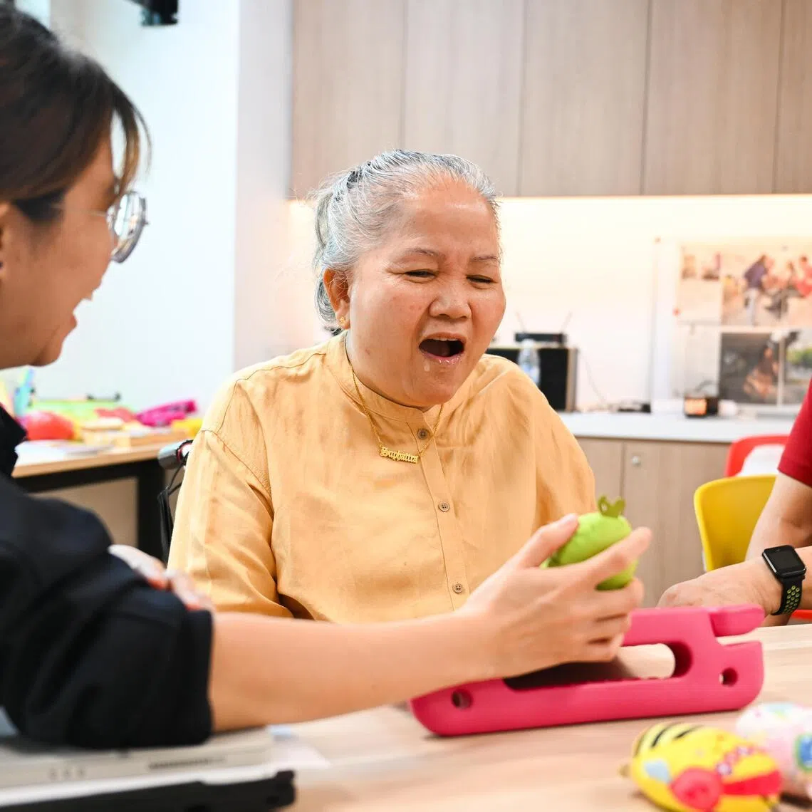 Madam Noi (right) with speech therapist Iris Lee, at S3@Jurong Point in December 2025. She attends speech therapy twice a week.