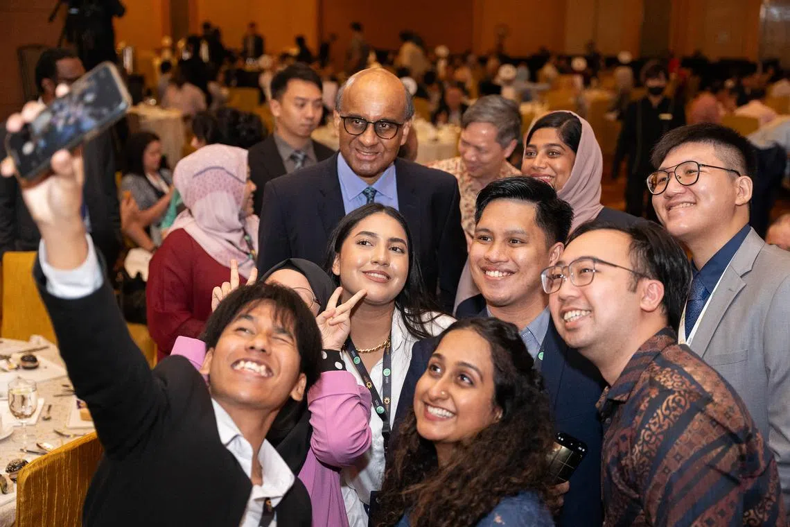 Former senior minister Tharman Shanmugaratnam posing for photos with attendees at the Exemplary Interfaith Award presentation ceremony on July 29.