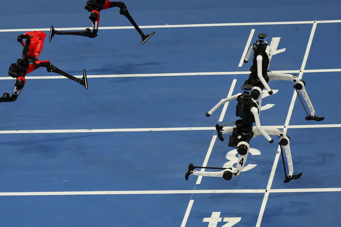 Tiangong Ultra humanoid robots cross the finish line before Honor's Lightning humanoid robots in the 100m large-size group final race, during the second World Humanoid Robot Games at the National Speed Skating Oval in Beijing, China August 26, 2026. REUTERS/Florence Lo