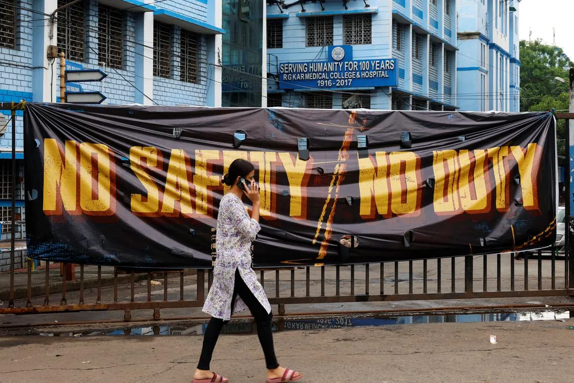 FILE PHOTO: A woman walks past a closed gate of R G Kar Medical College and Hospital in Kolkata, India, August 19, 2024. REUTERS/Sahiba Chawdhary/File Photo