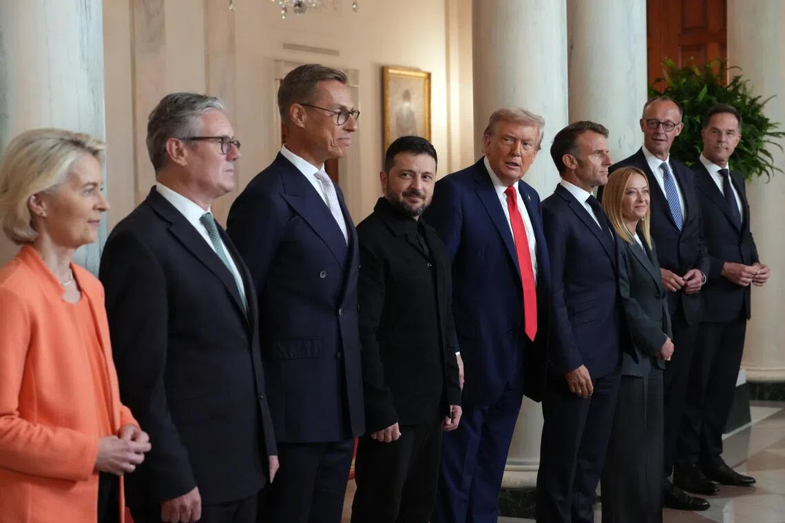 HEADLINE: Zelensky and Allies Press Trump for Security Guarantees
CAPTION: President Donald Trump, fifth from left, poses for a group photo with President Volodymyr Zelenskyy of Ukraine and other European leaders at the White House in Washington on Monday, Aug. 18, 2025. From left: President Ursula von der Leyen of the European Commission; Prime Minister Keir Starmer of the United Kingdom; President Alexander Stubb of Finland; Zelenskyy; Trump; President Emmanuel Macron of France; Prime Minister Giorgia Meloni of Italy; Chancellor Friedrich Merz of Germany; and NATO Secretary General Mark Rutte. 
CREDIT: (Doug Mills/The New York Times)