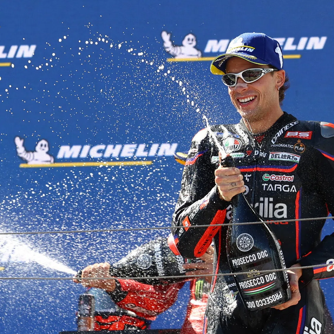 FILE PHOTO: MotoGP - Hungarian Grand Prix - Balaton Park Circuit, Balatonfokajart, Hungary - August 24, 2025 Aprilia Racing's Marco Bezzecchi celebrates on the podium after finishing third in the MotoGP race REUTERS/Bernadett Szabo/File Photo