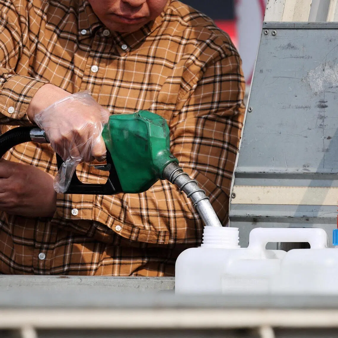 A man fills up a petrol can at a petrol station in Seoul, South Korea, March 9, 2026. 
