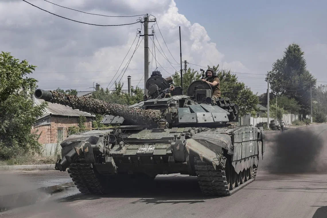 A Ukrainian tank drives near the front line, in Ukraine’s eastern Kharkiv region.