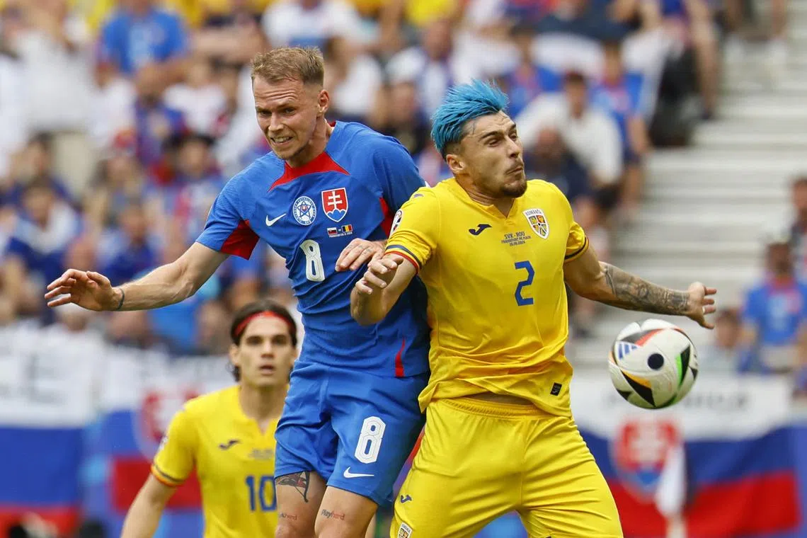 Soccer Football - Euro 2024 - Group E - Slovakia v Romania - Frankfurt Arena, Frankfurt, Germany - June 26, 2024 Slovakia's Ondrej Duda in action with Romania's Andrei Ratiu REUTERS/Wolfgang Rattay