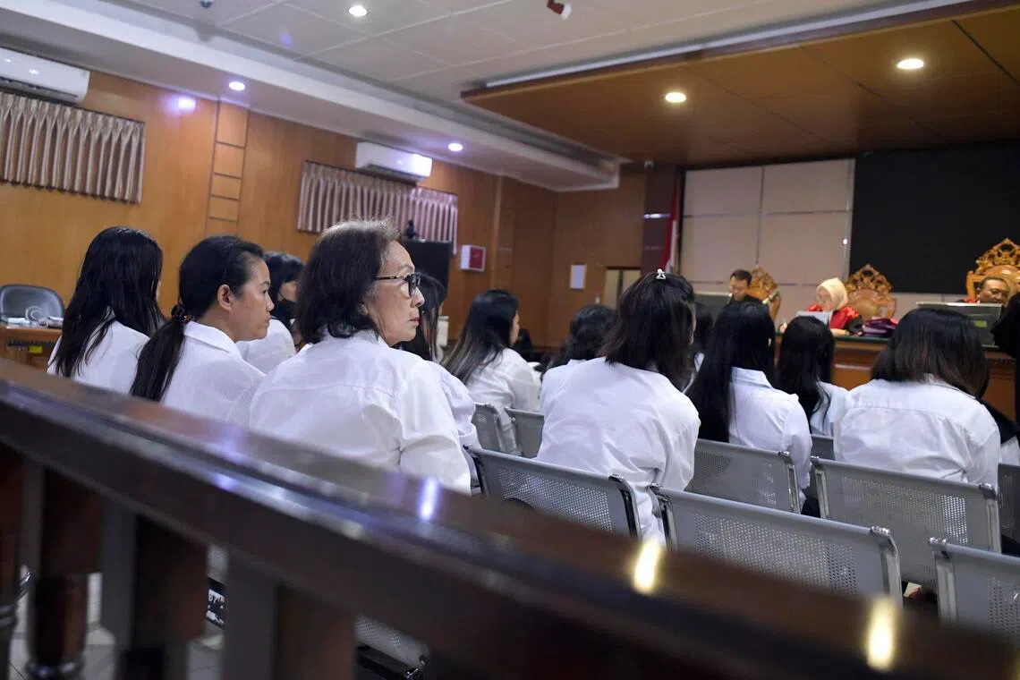 Ring leader Lie Siu Luan, alias Lily/Popo (centre), attends a human trafficking case hearing at the Bandung district court in West Java on April 7. 