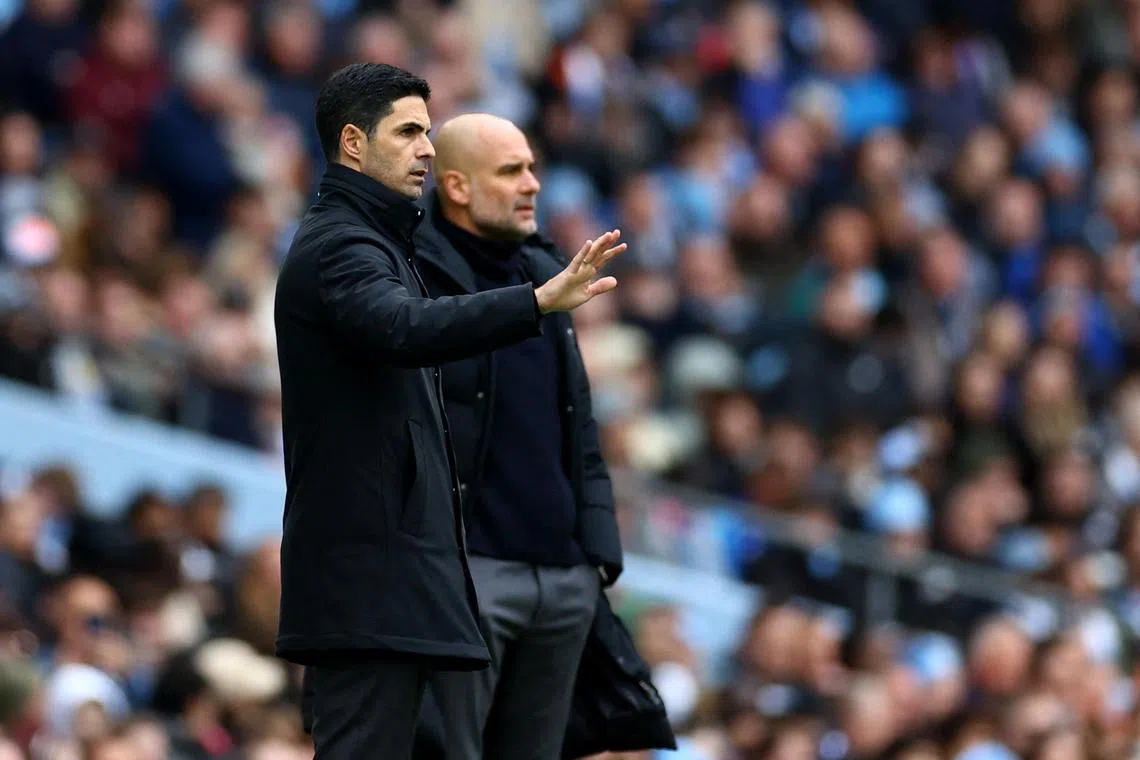 Arsenal manager Mikel Arteta (left) and Manchester City manager Pep Guardiola during the match on March 31.