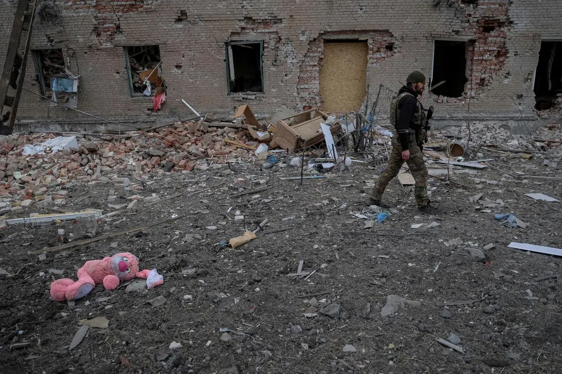 FILE PHOTO: A Ukrainian serviceman walks near destroyed building, amid Russia's attack on Ukraine, in the frontline town of Chasiv Yar in Donetsk region, Ukraine March 5, 2024. REUTERS/Oleksandr Ratushniak/File Photo
