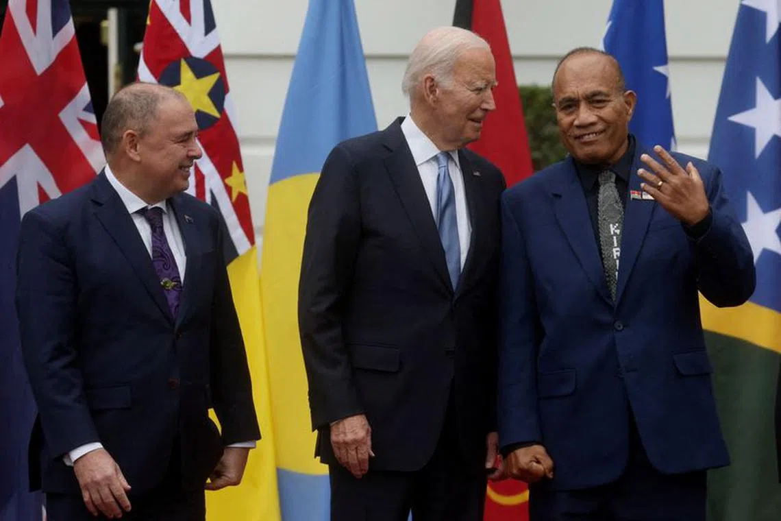 FILE PHOTO: U.S. President Joe Biden chats with President of Kiribati Taneti Maamau as Prime Minister of the Cook Islands Mark Brown stands next to them while Pacific Island nation leaders pose for a group photograph during a summit at the White House in Washington, U.S., September 25, 2023. REUTERS/Leah Millis/File Photo