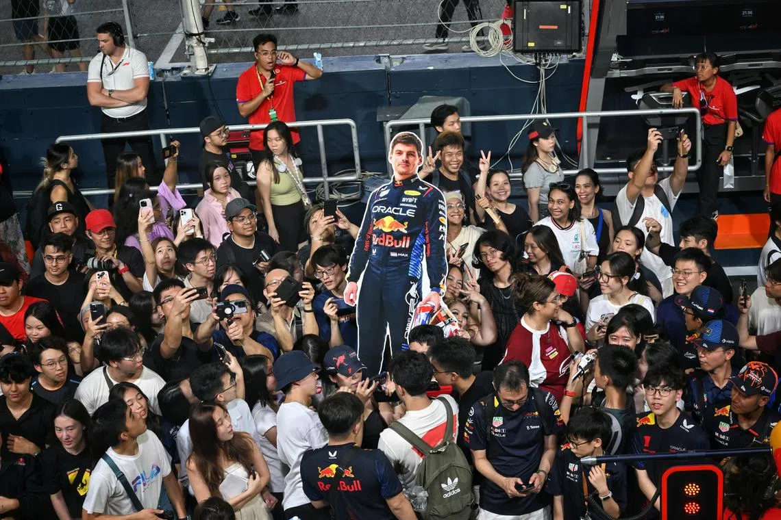 Fans with a cutout of Red Bull driver Max Verstappen during the pit-lane experience on Sept 19. 