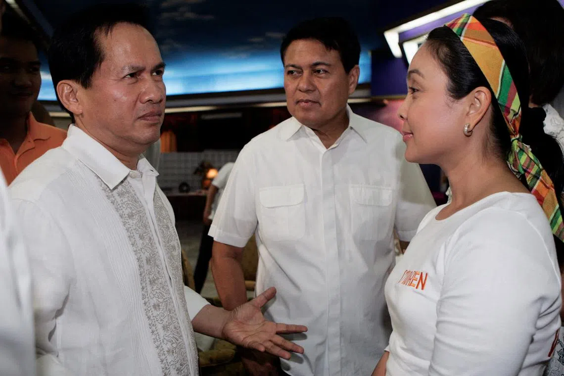 Filipinol evangelist pastor Apollo Quiboloy (L) welcomes senator and presidential candidate Manuel Villar (C) and his vice-presidential candidate Loren Legarda during his 60th birthday celebration in Davao city, southern Philippines April 25, 2010.  REUTERS/Romeo Ranoco/File Photo