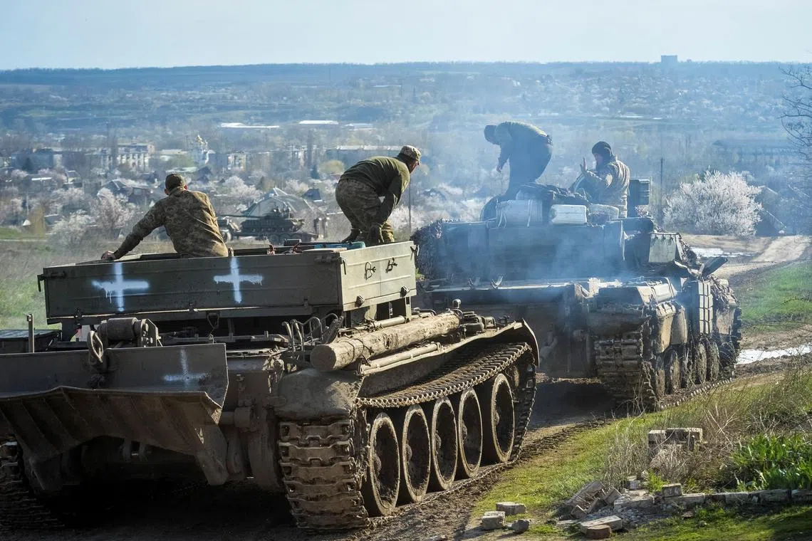 Ukrainian serviceman ride tanks near the front line city of Chasiv Yar, in Ukraine.