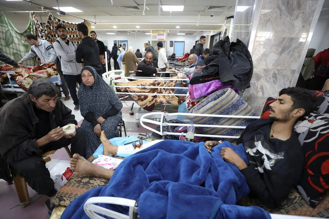 Palestinians who were wounded in Israeli fire while waiting for aid, according to health officials, lie on beds at Al Shifa hospital, amid the ongoing conflict between Israel and Hamas, in Gaza City, March 1, 2024. REUTERS/Kosay Al Nemer