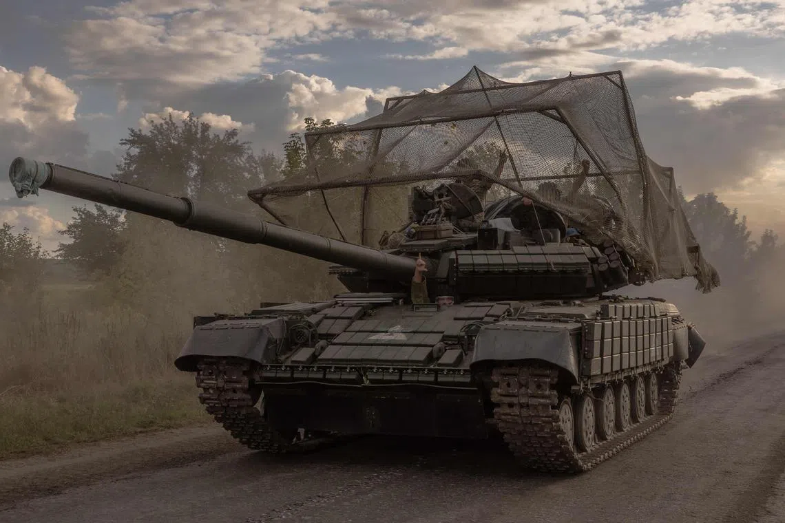 Ukrainian servicemen drive a Soviet-made T-64 tank in the Sumy region.