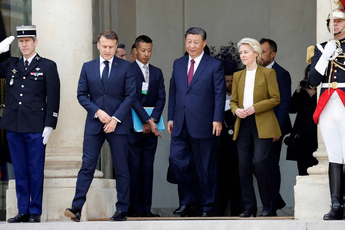 (From left) French President Emmanuel Macron, Chinese President Xi Jinping and European Commission president Ursula von der Leyen leave after their trilateral meeting  in Paris.