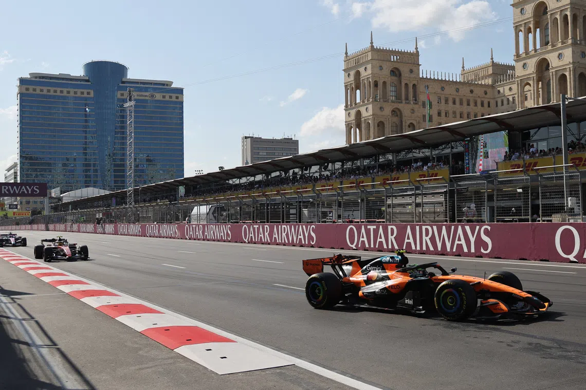Formula One F1 - Azerbaijan Grand Prix - Baku City Circuit, Baku, Azerbaijan - September 26, 2026 McLaren's Lando Norris in action during the race as Azadliq Square is seen in the background REUTERS/Jakub Porzycki