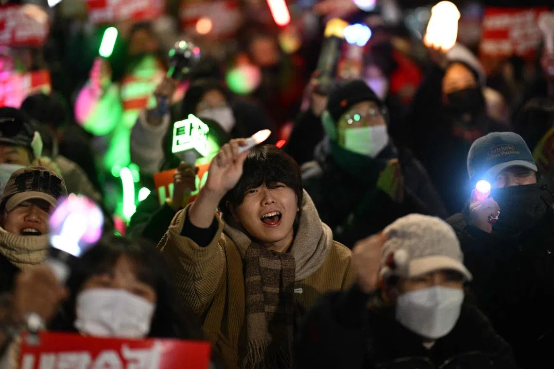 Demonstrators take part in a protest calling for the ouster of South Korea President Yoon Suk Yeol on the grounds of the National Assembly in Seoul on Dec 9, 2024. 