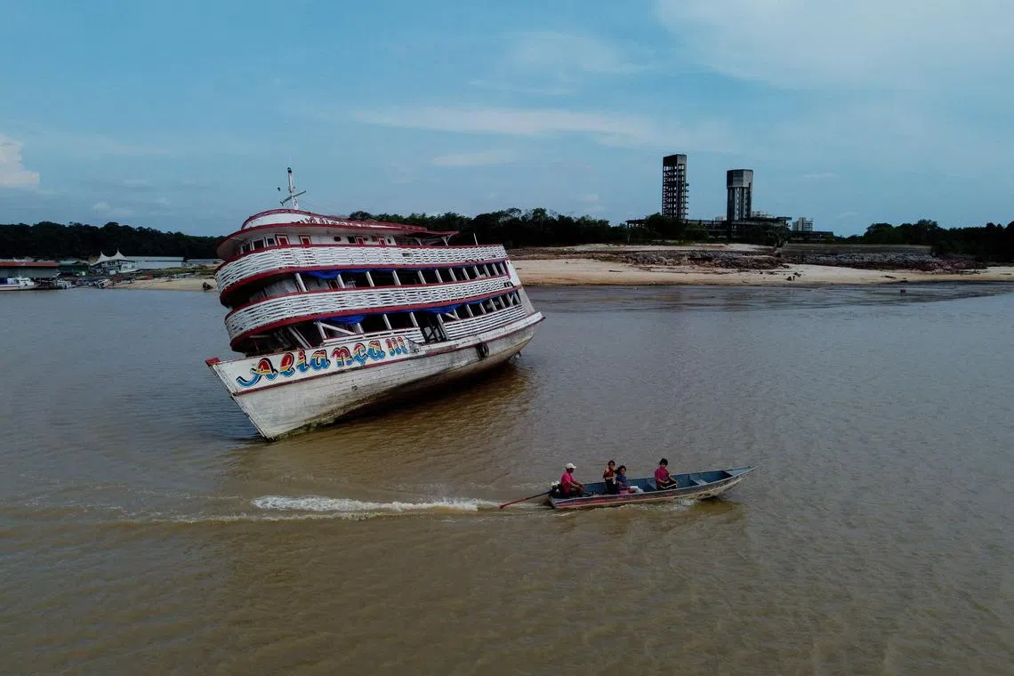 A stranded ferry boat at the Marina do Davi, a docking area of the Negro river, city of Manaus, Amazonas State, northern Brazil on October 16, 2023. The Negro river is facing the worst dry season of the last decades in the Amazon rainforest. 