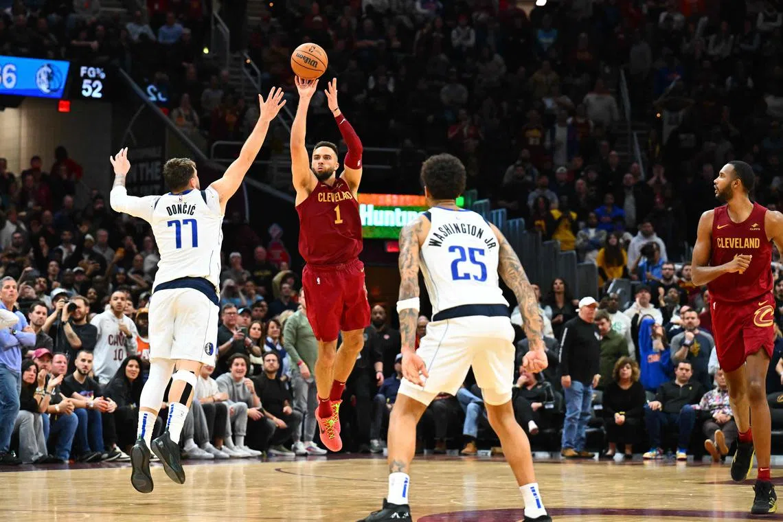 Max Strus of the Cleveland Cavaliers shoots a half-court shot over Luka Doncic of the Dallas Mavericks to win the game in the last second of the fourth quarter at Rocket Mortgage Fieldhouse.