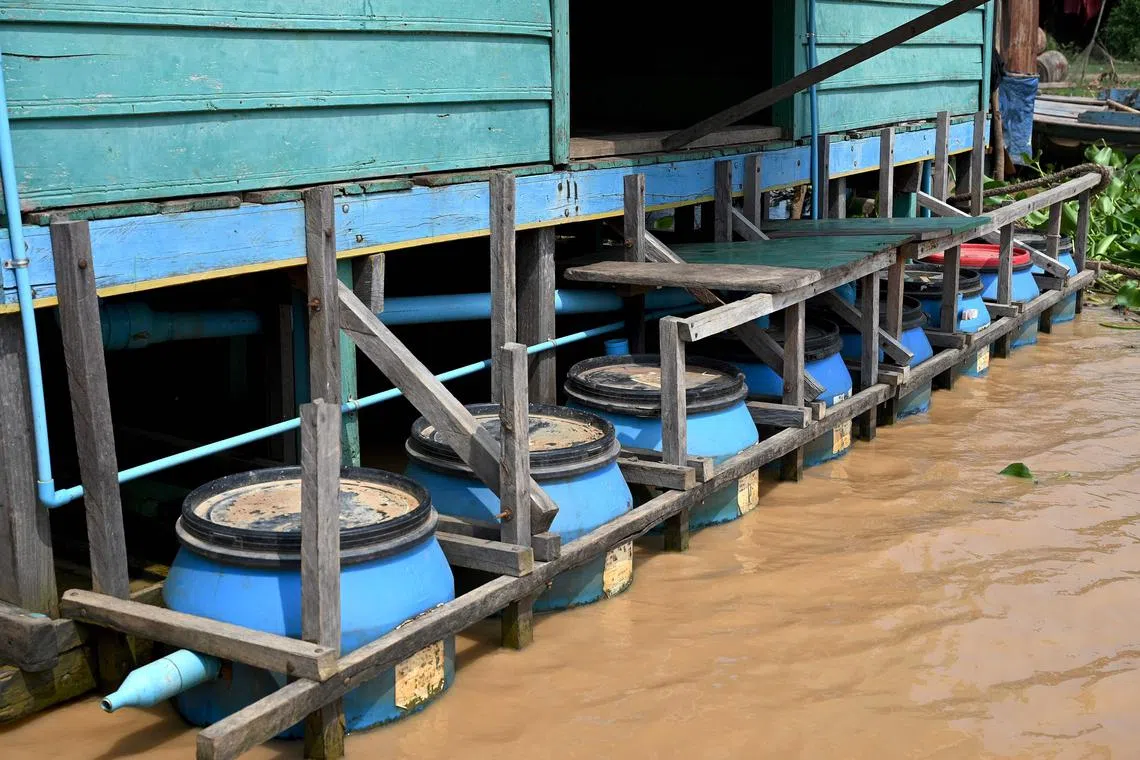 This photo taken on March 13, 2023 shows a floating toilets in Chong Prolay village on Tonle Sap lake in Siem Reap province. - Around 100,000 people living in floating houses on Cambodia's vast inland waterway have no sanitation system. A local social enterprise, Wetlands Work (WW), is trying to tackle the problem by rolling out "floating toilets" to filter waste. (Photo by TANG CHHIN Sothy / AFP) / To go with 'CAMBODIA-ENVIRONMENT-WATER,FOCUS' by Suy SE
