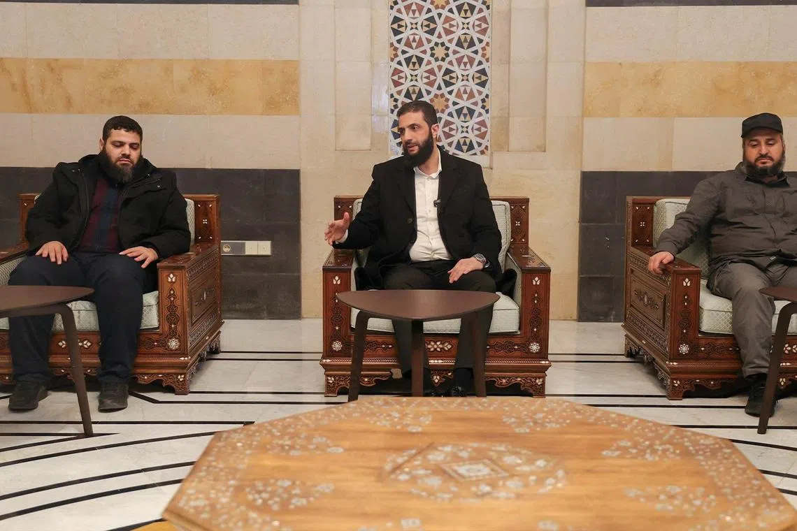 The head of Hayat Tahrir al-Sham and Syria's de facto leader, Ahmed al-Sharaa (centre) sitting next to Murhaf Abu Qasra (right), who according to an official source, has been appointed Defence Minister in Syria's interim government, in this photo released on Dec 21. 