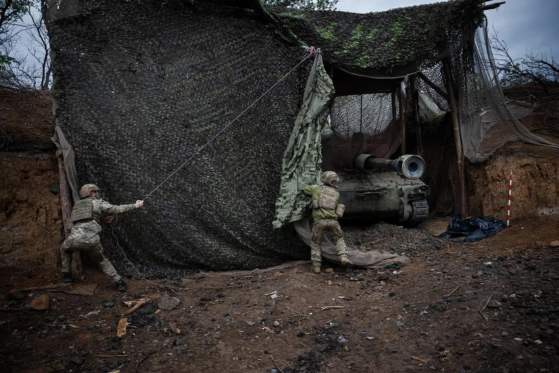 A Ukrainian artillery unit fires an M109 howitzer on Russian positions in eastern Ukraine.