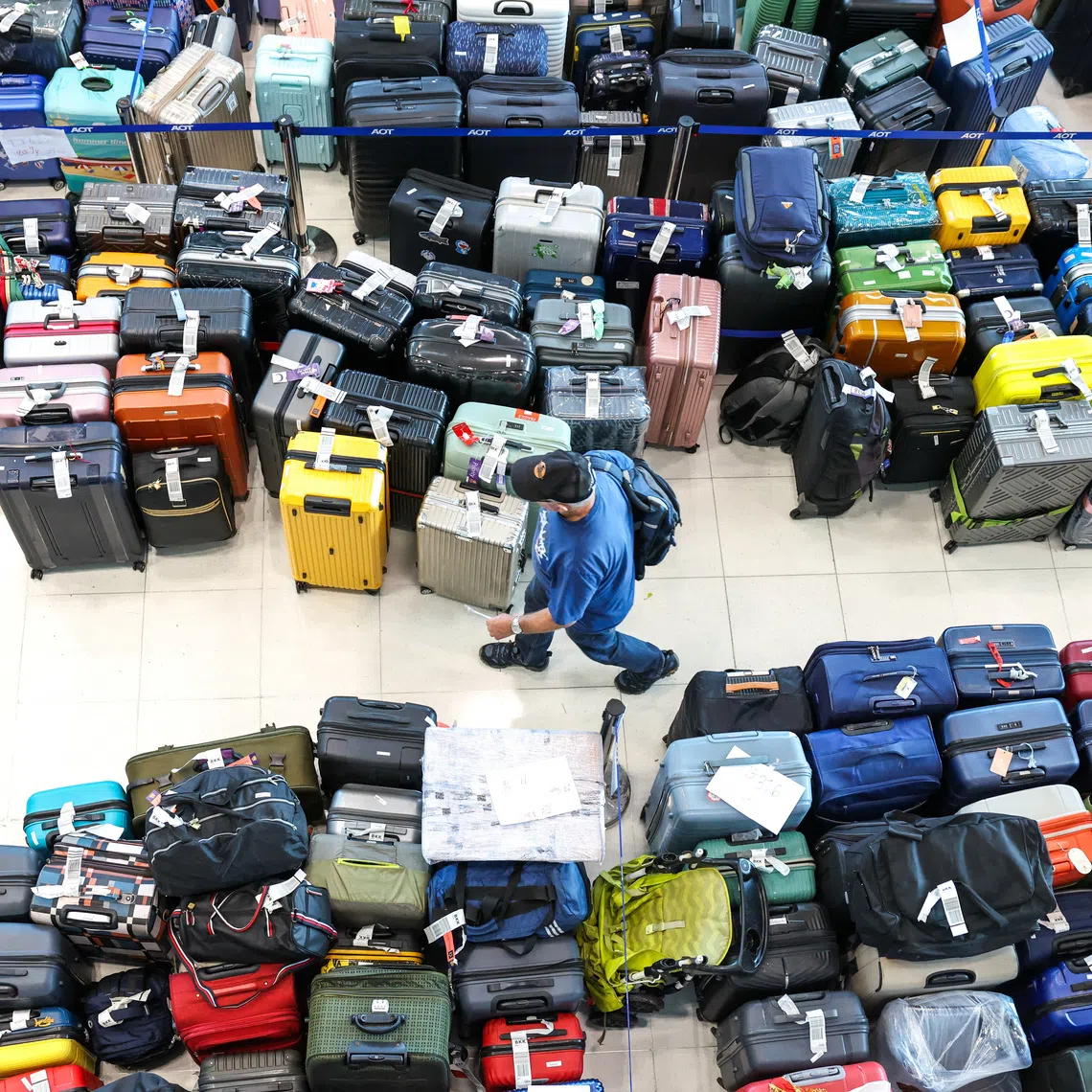 A passenger searches for his delayed baggage at Suvarnabhumi International Airport, after heavy rain and flooding disrupted Thai Airways’ ground operations, in Bangkok, on Sept 29.