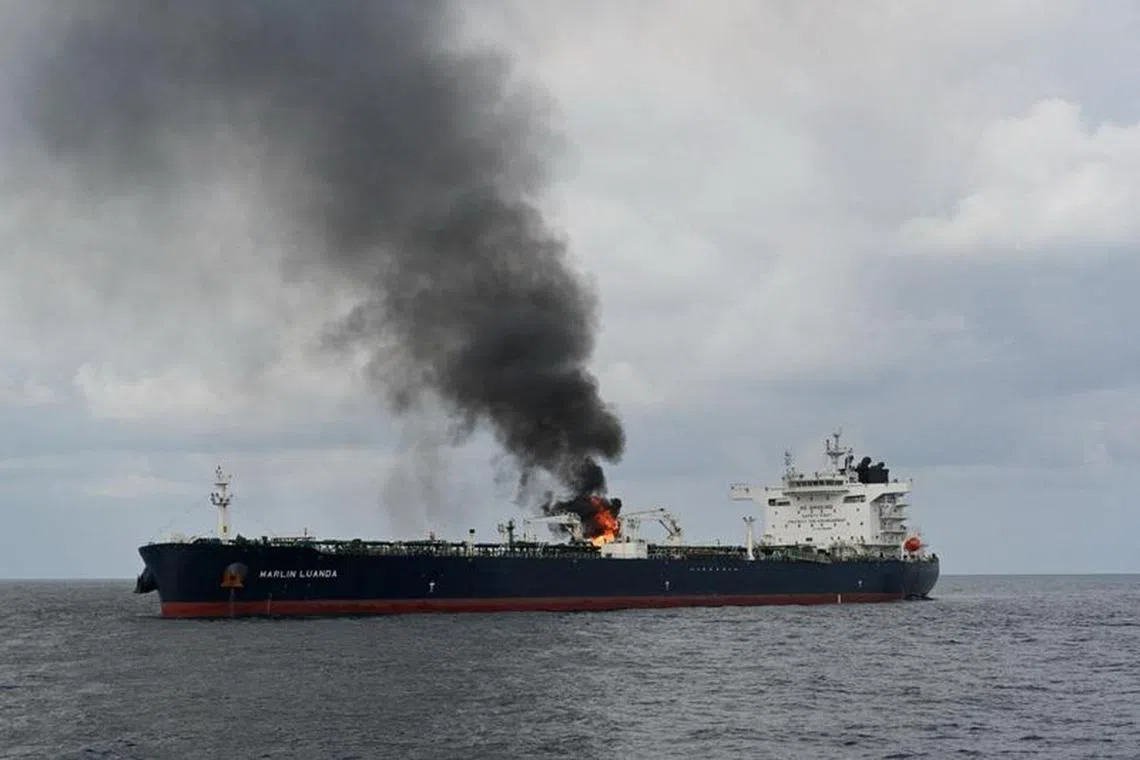 Smoke rises from Marlin Luanda, merchant vessel, after the vessel was struck by a Houthi anti-ship missile, at the location given as Gulf of Aden, in this handout picture released January 27, 2024. @indiannavy via X/Handout via REUTERS