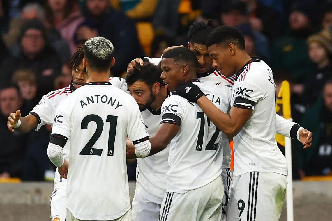 United's Marcus Rashford celebrates scoring their first goal with teammates.
