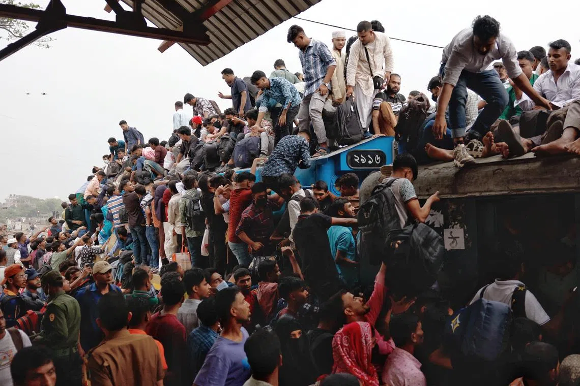 People climbing on top of a train as they leave Dhaka to celebrate Eid al-Fitr, which marks the end of the Muslim holy fasting month of Ramadan, at Tongi Railway Station in Gazipur, Bangladesh.