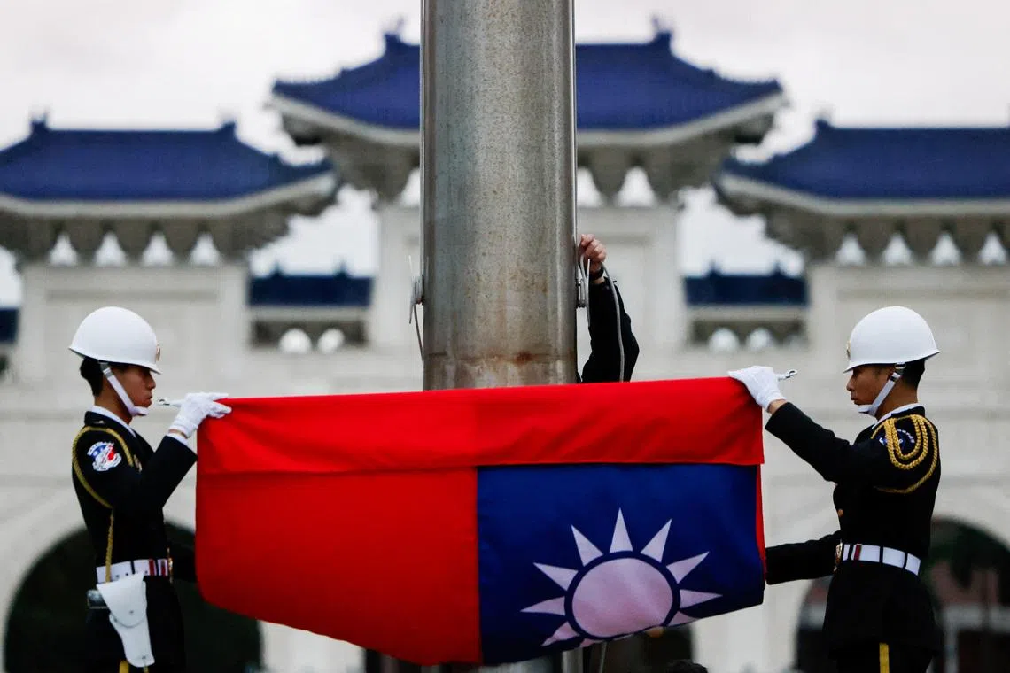 Taiwan's flag is lowered during a daily ceremony as China conducts \"Justice Mission 2025\" military drills around Taiwan, in Taipei, Taiwan, December 30, 2025. REUTERS/Ann Wang