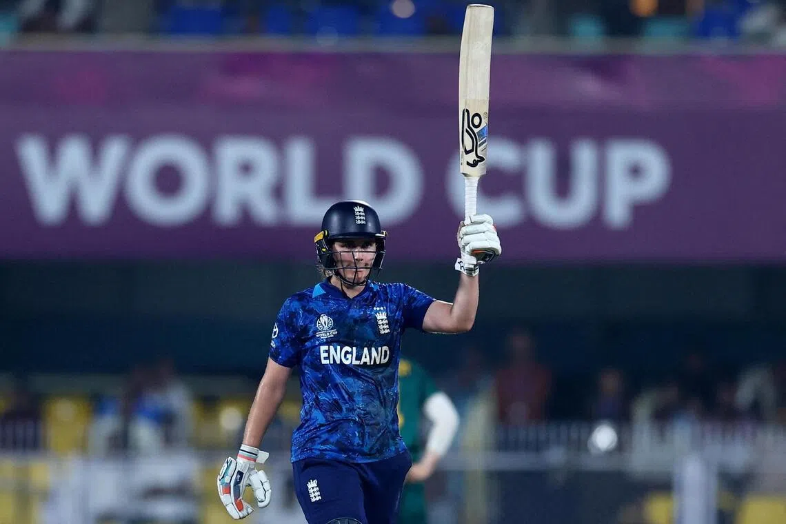 England's Nat Sciver-Brunt celebrates after reaching her half century in the cricket Women's World Cup semi-final against South Africa at the Barsapara Cricket Stadium in Guwahati, India on Oct 29, 2025.