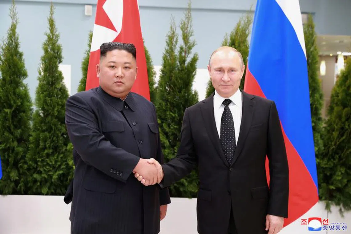 FILE PHOTO: North Korean leader Kim Jong Un shakes hands with Russian President Vladimir Putin in Vladivostok, Russia in this undated photo released on April 25, 2019 by North Korea's Central News Agency (KCNA). KCNA via REUTERS