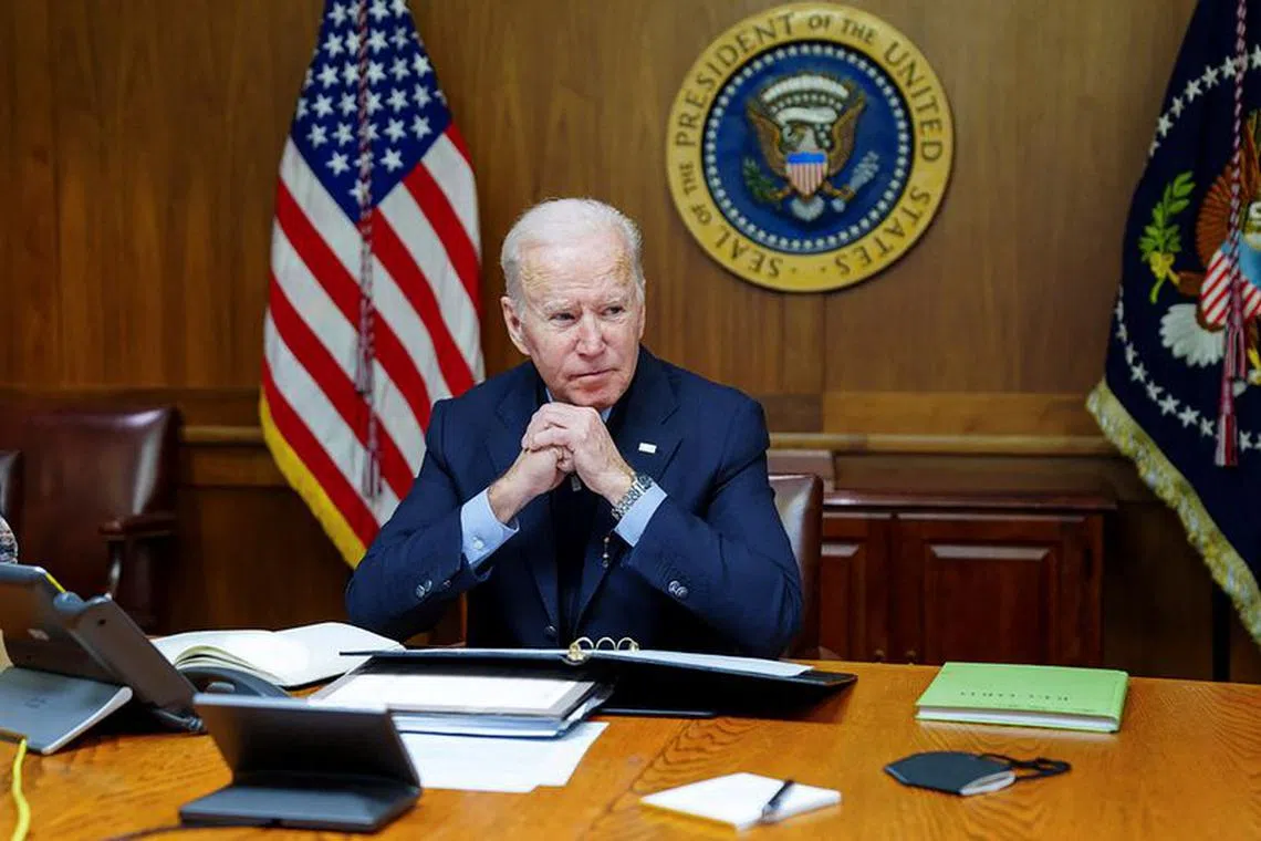 U.S. President Joe Biden speaks on the phone with Russia's President Vladimir Putin about a possible Russian invasion of Ukraine, as Biden spends the weekend at the U.S. presidential retreat at Camp David, in this official White House handout photo released after the call took place in Thurmont, Maryland, U.S., February 12, 2022. The White House/Handout via Reuters/File Photo