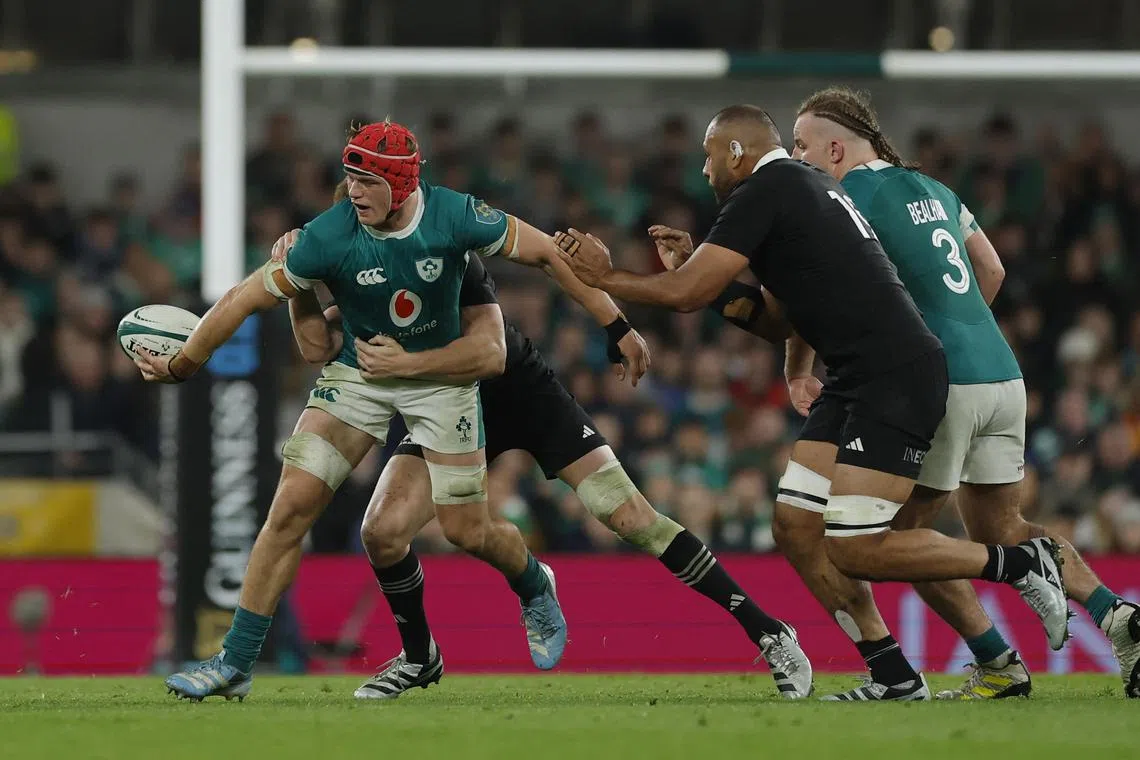 Ireland's Josh van der Flier clashing with New Zealand players during their 23-13 loss on Nov 8.