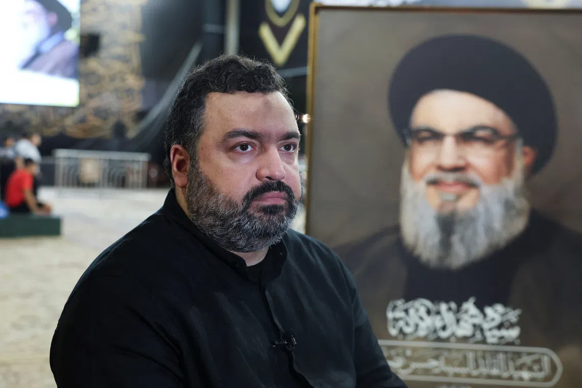 Jawad Nasrallah, son of late Hezbollah leader Hassan Nasrallah, sits at the burial site ahead of the first anniversary of his father's assassination, on the outskirts of Beirut, Lebanon September 24, 2025. REUTERS/Mohamed Azakir