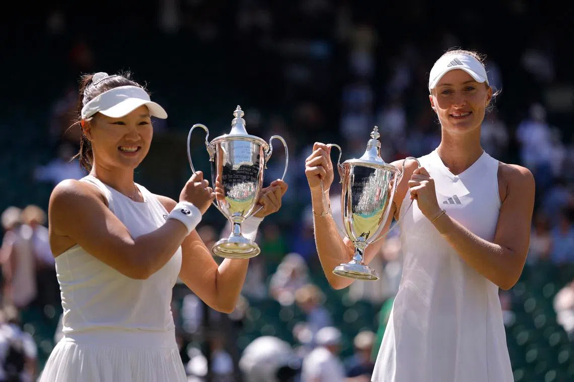 Tennis - Wimbledon - All England Lawn Tennis and Croquet Club, London, Britain - July 12, 2026 General view as China's Guo Hanyu and France's Kristina Mladenovic celebrate with the trophies after winning their women's doubles final match against Canada's Gabriela Dabrowski and Brazil's Luisa Stefani REUTERS/Andrew Couldridge