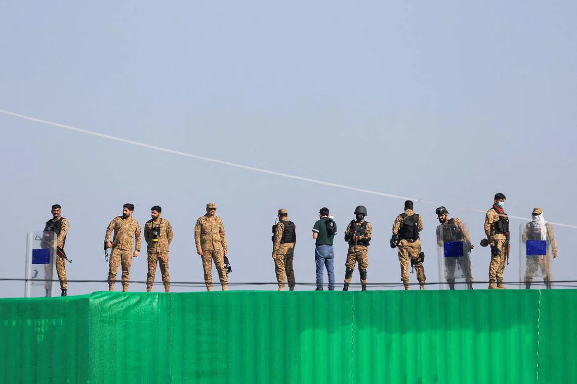 Pakistani Army soldiers standing guard over a shipping container used to block the road leading to the parliament house, to block an anti-government protest rally by supporters of the former Pakistani Prime Minister Imran Khan's party Pakistan Tehreek-e-Insaf (PTI) demanding the release of Khan, in Islamabad, Pakistan Nov 26, 2024.
