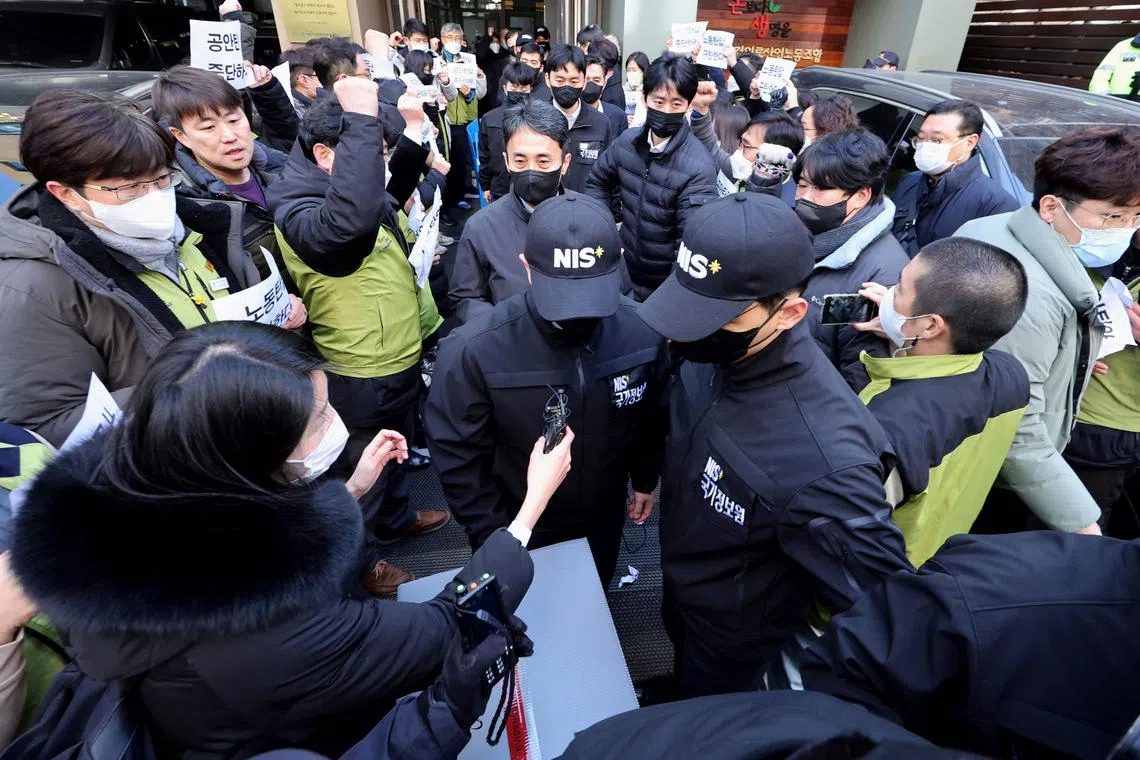 Officials from the National Intelligence Service carrying a box in front of the headquarters of the Korean Health and Medical Workers' Union of the Korean Confederation of Trade Unions  in Seoul on Jan 18. 